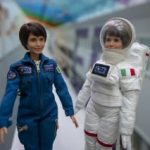 Two astronaut dolls getting ready for space launch
